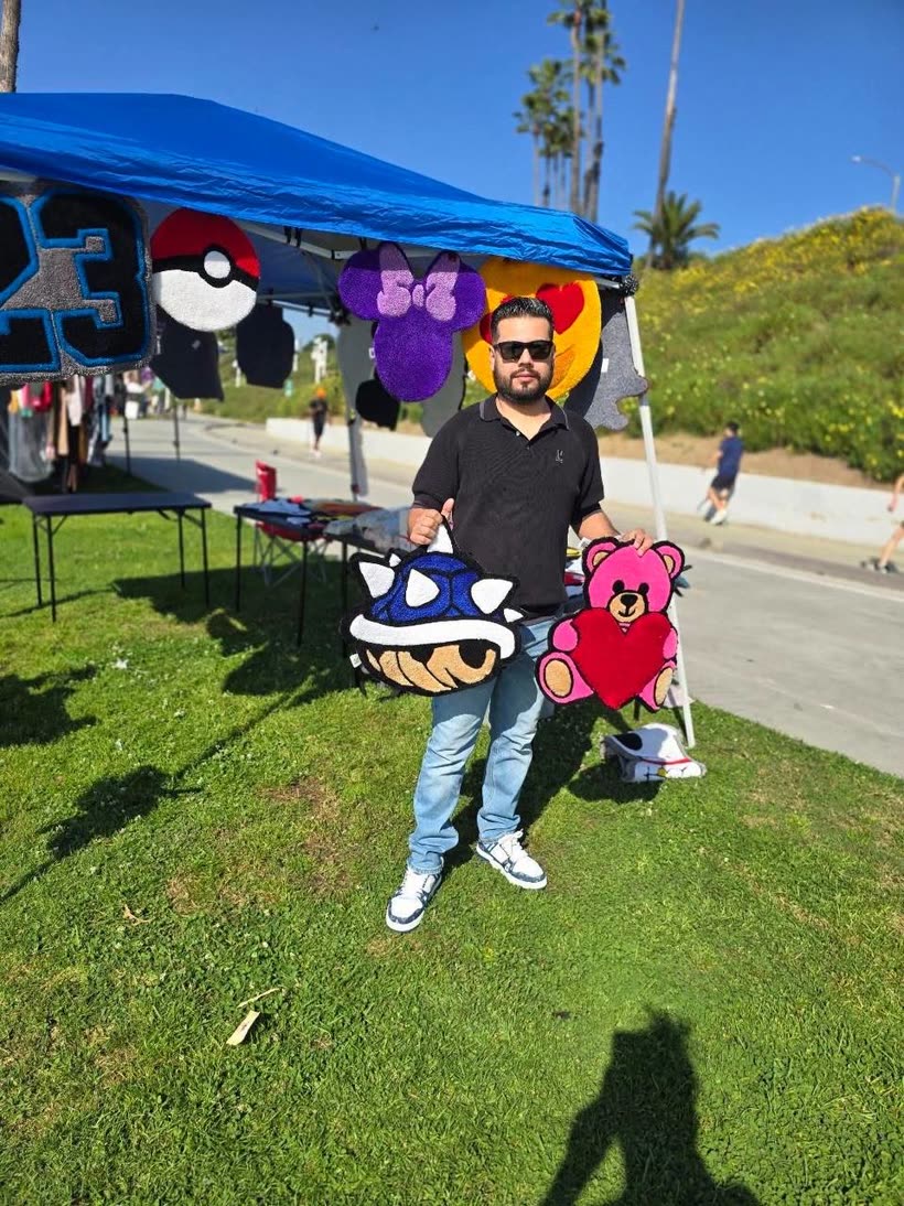 Happy customer holding a custom LA Rams logo rug
